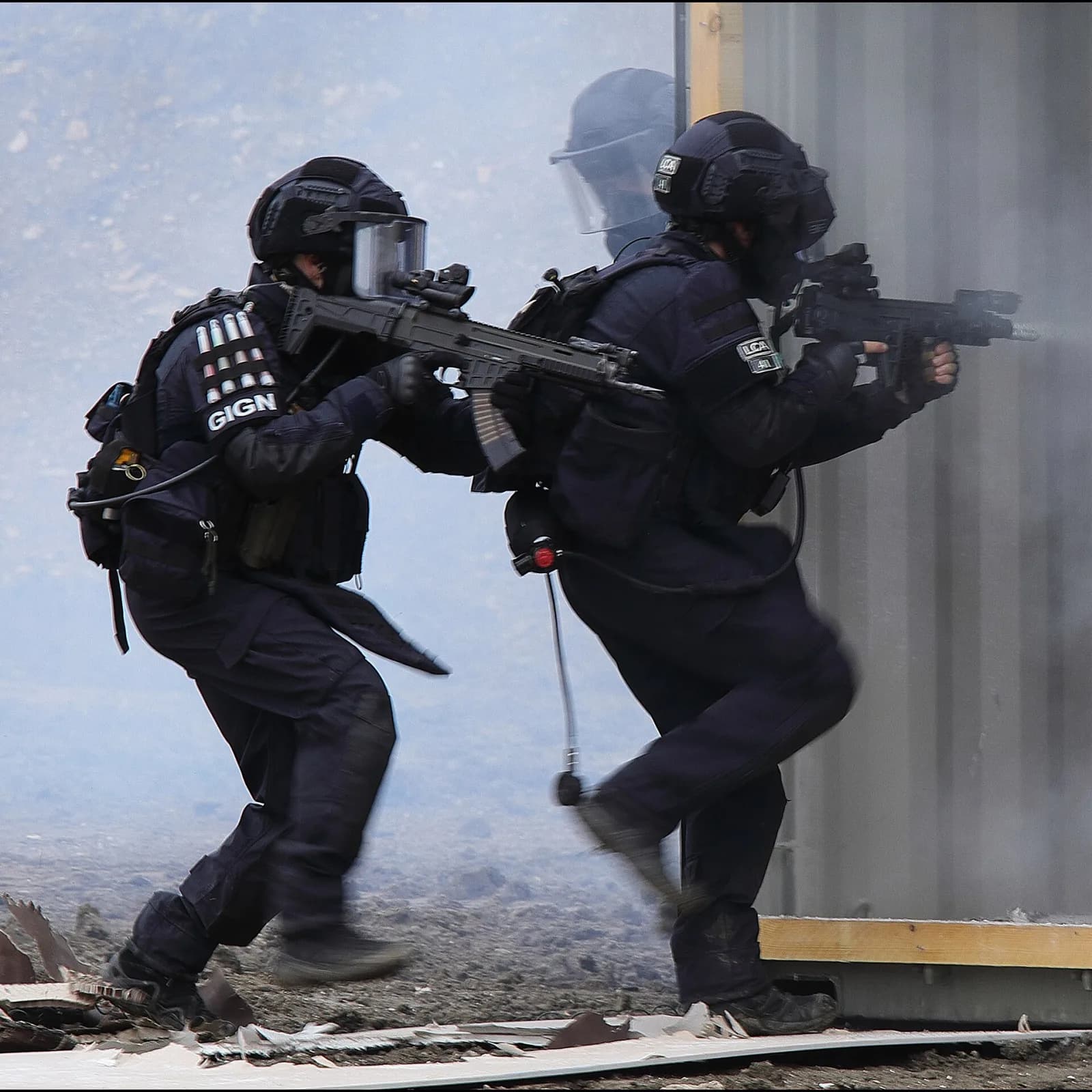 Opérateurs du GIGN pénétrant dans un bâtiment sous couvert de fumigène